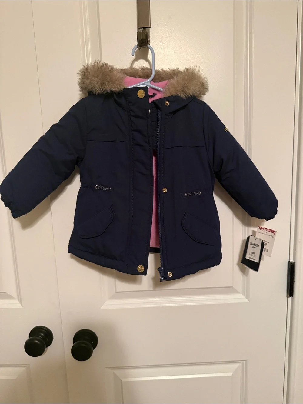 Girls winter coat with hood. Navy blue outside with pink fleece inside